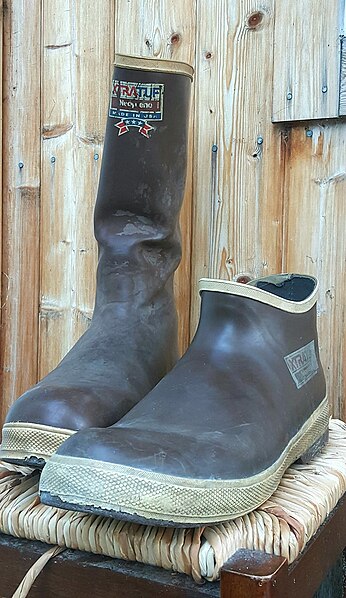 Two styles of well-worn Xtratuf boots made with neoprene