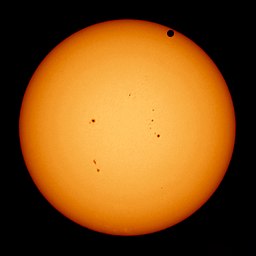 A filtered image of the Sun in visible light, showing the limb-darkening effect as a dimmer luminosity towards the edge or limb of the solar disk. The image was taken during the 2012 transit of Venus (seen here as the dark spot at the upper right). 2012 Transit of Venus from SF.jpg