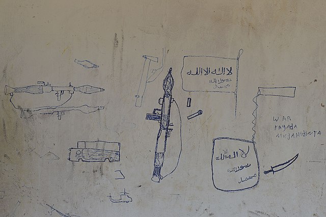 Drawings left by fighters on the walls of a building in El Baraf.