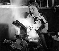 A young woman arc welding in a munitions factory in Australia in 1943 Arc welding part of an anti-tank gun.jpg