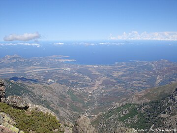 a remote view to Pointe de la Revellata and Calvi