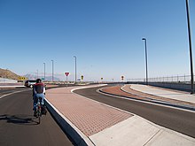 Bicyclist rides through main lane of roundabout