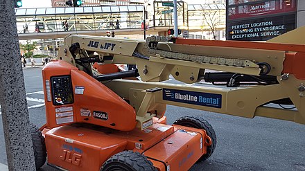 A JLG brand articulating boom lift rented from BlueLine Rental.