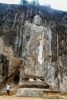 The gigantic standing Buddha - at 16m, it is the tallest on the island - in the centre still bears traces of its original stuccoed robe, and a long streak of orange suggests it was once brightly painted Buduruwagala-height.jpg