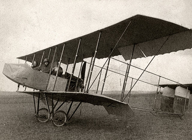 A 1912 Farman HF.20 biplane with single acting ailerons hinged from the rear spar. The ailerons hang down when at rest and are pushed up into position