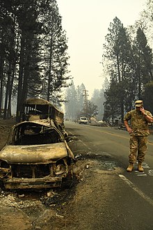 Burnt out vehicles abandoned along the evacuation route California National Guard (32035893148).jpg