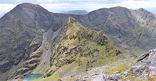 View from Beenkeragh of the Beenkeragh Ridge (with The Bones, in green, at its centre) to Carrauntoohil (left); back and right is Caher Ridge showing Caher East Top, and Caher West Top.