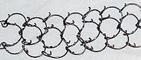 Closeup of a cilice--a small metal chain with inwardly pointing spikes Cilice3.jpg