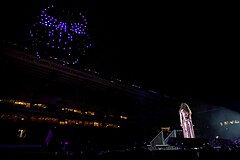 Corinne Bailey Rae on stage looking up at the drone art Giant. The Awakening. LEEDS 2023.jpg