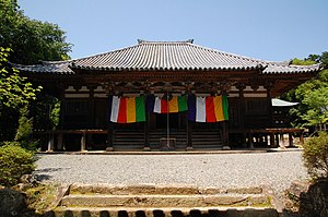 Wooden building with raised floor and a wide staircase.