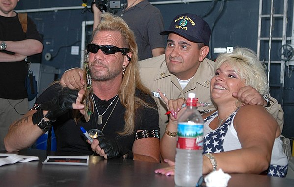 Dog and Beth Chapman signing autographs during a visit aboard the nuclear-powered aircraft carrier USS Nimitz on May 20, 2005, Pearl Harbor, Hawaii.