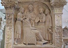 Four ancillae assisting their mistress, on a funerary relief from Roman Germany (ca. 220 AD) Funerary relief from Neumagen depicting a woman's hair being dressed by her slaves, circa 220 AD, Rheinisches Landesmuseum Trier, Germany (34626922225).jpg