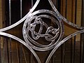 Knot ornament on closed gate of mathematics department at night