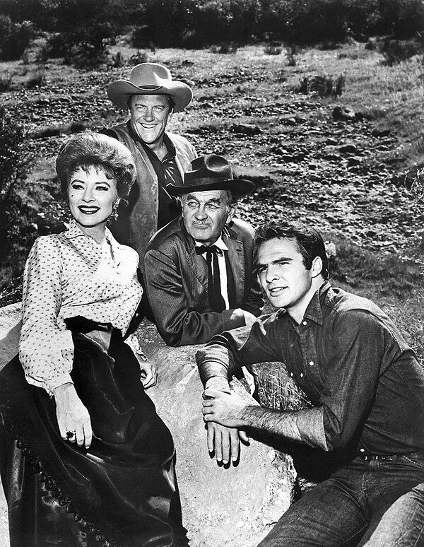 1963 Gunsmoke cast: Amanda Blake (Kitty), Arness (Matt Dillon), Milburn Stone (Doc Adams), and Burt Reynolds (Quint Asper)