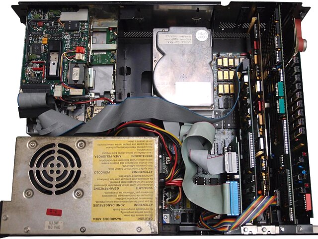 Internal view of the IBM PC (from the back), showing components and layout. This PC has been outfitted with aftermarket floppy and hard disk drives, b
