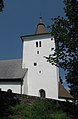 Románská věž kostela svatého Mořice v Mouřenci. Makovice věže kostela je geodetickým bodem TB 2914-11.0.