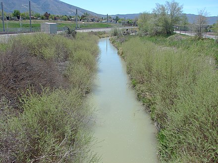 Looking south along the East Jordan Canal at the Sandy Civic Center TRAX station in Sandy, April 2015 Looking south along canal Sandy Civic Center.JPG