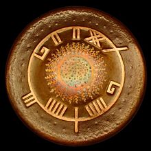 William Winant's bronze gong (28 inches diameter) made by the English drummer and musical instrument maker Matt Nolan. The characters are in the ancient Irish writing system Ogham. The text is read from top in the clockwise direction: <phllpm phnant>. Transcription: UILLIAM UINANT (William Winant). MattNolanBronzeGong.jpg