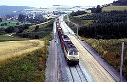 A construction freight train passes Mittelsinn Bridge, headed south.