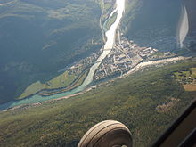 The confluence of the river Otta (entering from top) and Lågen (entering from the right). Otta river has a milky-turquoise appearance from rock flour from glaciers upstream, such as Jotunheimen.