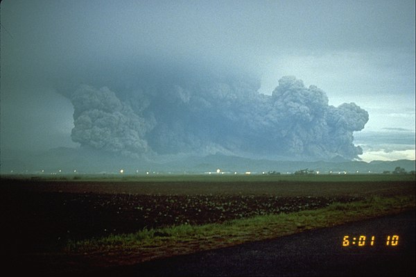 The colossal eruption of Mount Pinatubo on June 15, partially obscured by rainclouds from Yunya