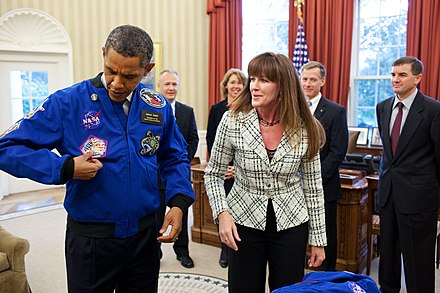 The crew presents President Obama with a NASA flight jacket from the final mission.