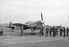 King George VI and his entourage of senior RAF officers walk over to Hawker Typhoon Mark IB, MN454 'HF-S', of No. 183 Squadron RAF, while inspecting aircraft and equipment which will be used in the forthcoming invasion of Normandy at Northolt, Middlesex. MN454 was flown by F H Scarlett, the Commanding Officer of 183 Squadron. Royal Air Force- 2nd Tactical Air Force, 1943-1945. CH13240.jpg