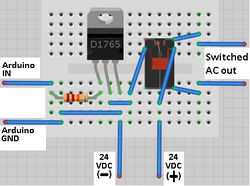 a computer generated image of electronic parts on a breadboard connected as a switching amplifier