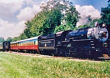 GSMR's bright "circus train" livery is seen behind steam locomotive No. 1702 The Great Smoky Mountains Railway is pictured in the 1990s with its bright "circus train" livery.jpg