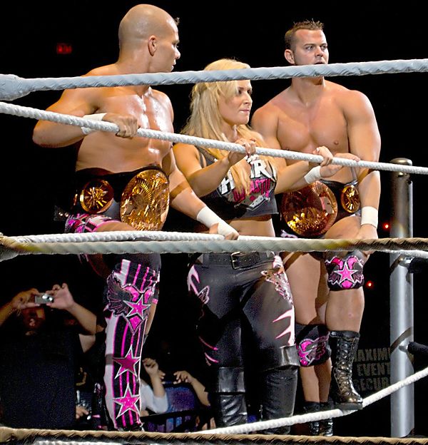 The Hart Dynasty (from left to right) Tyson Kidd, Natalya, and Smith as the WWE Tag Team Champions in August 2010