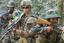 Two Indian soldiers with the INSAS. The two types of INSAS assault rifle include the 1B1 (rear) and the original (front). Training in India (31552736368).jpg