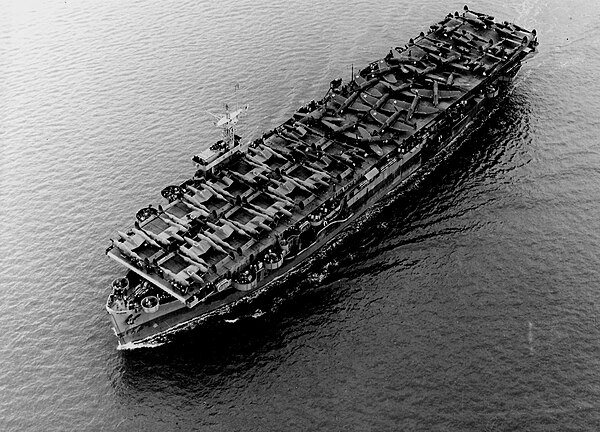 The US Navy escort carrier Barnes underway in the Pacific Ocean, on 1 July 1943, transporting US Army Air Forces Lockheed P-38 Lightning and Republic 