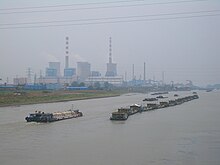 The modern route of the Grand Canal passes within a few kilometers east of the city's main urban area. Yangzhou-Modern-Grand-Canal-barge-caravan-3342.JPG