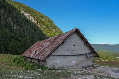 The alp above the upper Fusine lake, Fusine di Valromana, Tarvisio, Friuli. View from the barn on the municipality alp to north. In the distance the Dobratsch, Carinthia