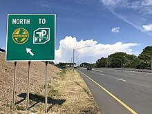 Signage directing traffic to both NJTA-maintained highways 2020-08-22 13 25 28 View north along U.S. Route 9 at the exit for the Garden State Parkway NORTH (TO New Jersey Turpike) in Woodbridge Township, Middlesex County, New Jersey.jpg