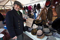 Hat stall owner in a sunday fair. Amsterdam, The Netherlands