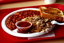 Typical plate of chopped pork barbecue as served in a restaurant with barbecue beans, sauce, and Texas toast Arkansas BBQ 001.jpg