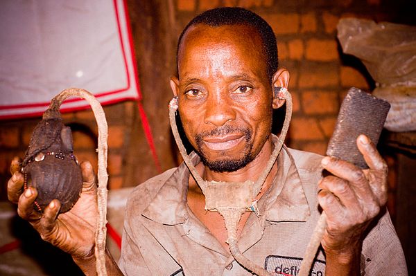 A Yao traditional doctor shows his homemade stethoscope he uses for treatment