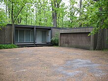 Een bruin modernistisch vierkant huis en garage is afgebeeld