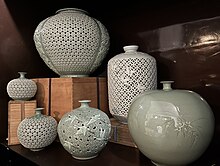Collection of mostly double-open work celadon vases including moon jars. Collection double-openwork celadon moon jars by artist Kim Se-yong and one openwork bottle vase.jpg