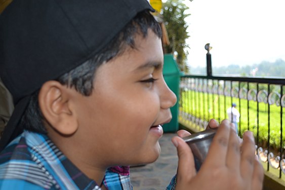 A child's contentment after he has first sip of hot chocolate milk in the hills of Munnar