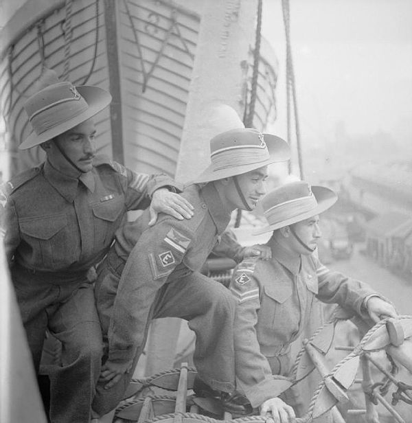 Three Iraqi Levies ground crews of the RAF, arrive at the docks at Liverpool, UK, 1946. Left to right: Sergeant Macko Shmos, Lance Corporal Adoniyo Od