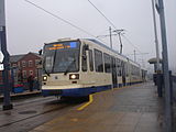 Sheffield Supertram vehicle 120 Creamy at Gleadless Townend in February 2011 during very wet weather.