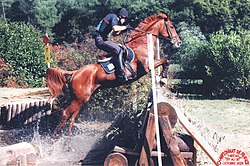 An eventer jumping out of the water Cross gue.jpg