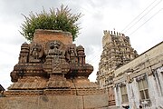 Decorative stone pot and gopura in the background at Sri Ranganathaswamy temple at Srirangapatna.jpg