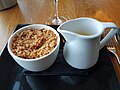 Dinner at the Greenbank Hotel, Falmouth, Cornwall - Rhubarb and Apple Crumble with custard (42643631792).jpg