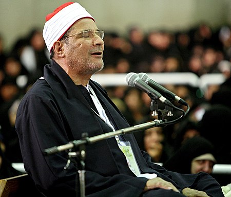 Farajollah Shazli Reading Quran in the Presence of Ali Khamenei in 2010 01 (cropped).jpg