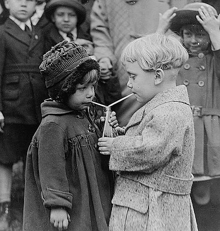 Two children sharing a soft drink at the White House.
