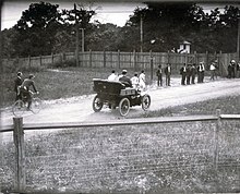 First runners leaving the stadium (Mellor and Spring in front of referees' automobile)