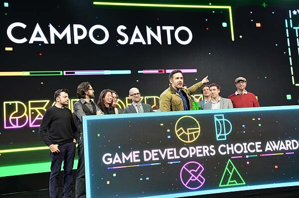 A group of game developers accepts a game developers' award.